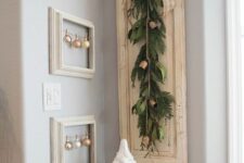 32 Christmas wall decor with empty frames with ornaments and a sign with an evergreen sawg and bells is a great idea