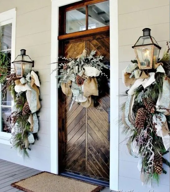 chic natural front door styling with mesh and burlap ribbons, evergreens, pinecones, berries, and whitewashed evergreens on the door
