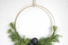 37 a modern Scandinavian Christmas wreath with evergreens, matte black ornaments and wooden geometric ornaments is wow