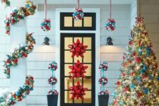 38 ornament topiaries hanging over the door, garlands and red bows on the door are amazing for styling for Christmas