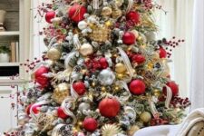 39 a gorgeous Christmas tree with gold, red and clear ornaments, berry branches, twigs and ribbons