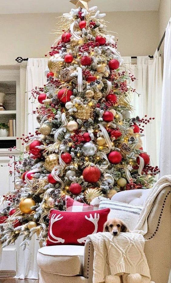 a gorgeous Christmas tree with gold, red and clear ornaments, berry branches, twigs and ribbons