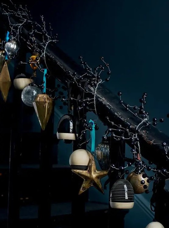dark Christmas stairs decor with bells, black berries and vintage ornaments for those who love moody decor and drama