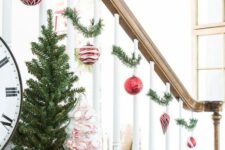42 evergreens paired with red and white ornaments are amazing Christmas banister decor with plenty of color