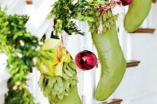43 evergreens, green stockings, red ornaments are an amazing colorful combo for your Christmas banister