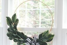 44 a stylish and timeless modern Christmas wreath done with magnolia leaves and a black and white ribbon bow