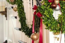 44 gold, red and brown ornaments, evergreens and deep red bows for decorating the railing for Christmas