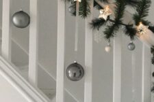 45 grey and white Christmas ornaments, evergreens and a star-shaped garland are an amazing combo for Christmas decor
