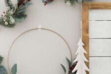 48 an arrangement of Christmas wreaths with leaves, evergreens, berries and bells is a lovely decor idea for the holidays