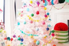 49 a white Christmas tree decorated with super bright ornaments and garlands, matching paper pompoms and a tree skirt