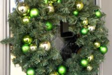 50 an evergreen Christmas wreath with green and gold ornaments is a stylish idea for the holidays