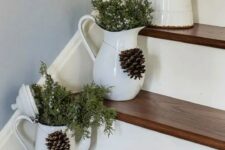 59 fresh juniper in vintage jugs placed right on the stairs, with pinecones will give a cozy rustic feel to your space