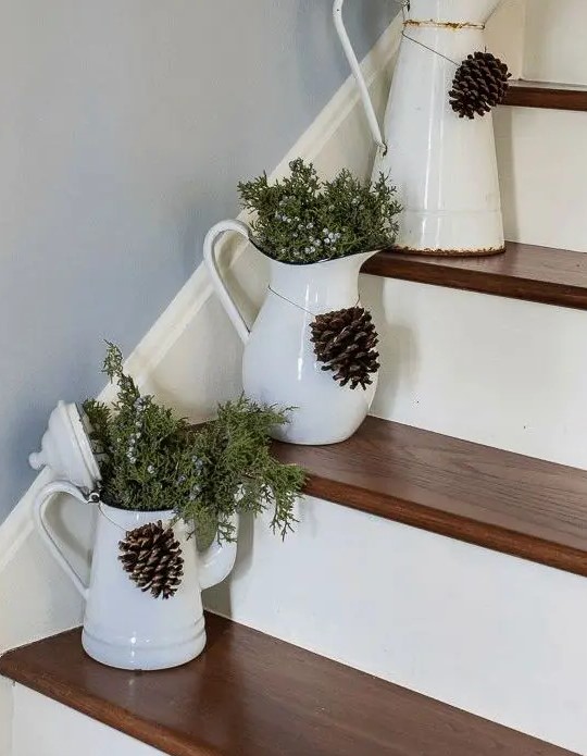 fresh juniper in vintage jugs placed right on the stairs, with pinecones will give a cozy rustic feel to your space