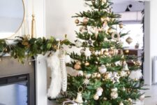 a Christmas tree with lights, silver, gold and copper ornaments, stars and snowflakes, vintage and modern ornaments