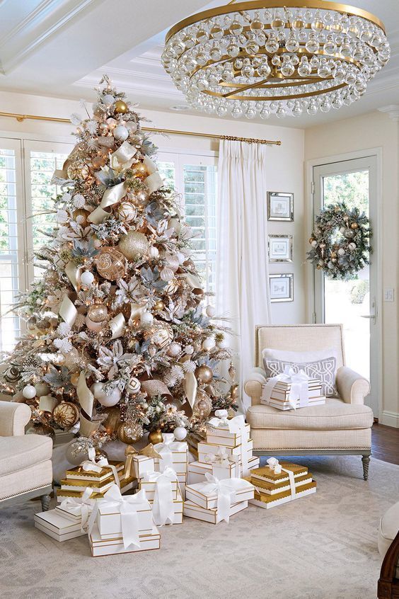 a beautiful and glam Christmas tree decorated with various metlalic ornaments, shiny ribbons, faux blooms and leaves