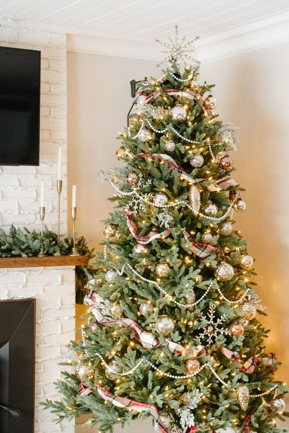 a beautiful and glam Christmas tree with metallic ornaments, beads, plaid ribbons, snowflakes and some lights