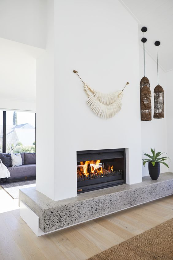 a beautiful double sided fireplace with a concrete shelf and some decor right on it is a lovely idea for any space