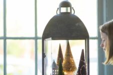 a creative Christmas lantern with bottle brush trees