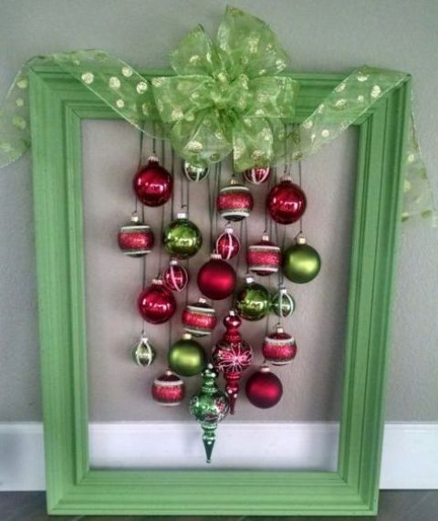 a bold green frame Christmas wreath of red and green ornaments and a green polka dot bow on top is a bold and cool idea