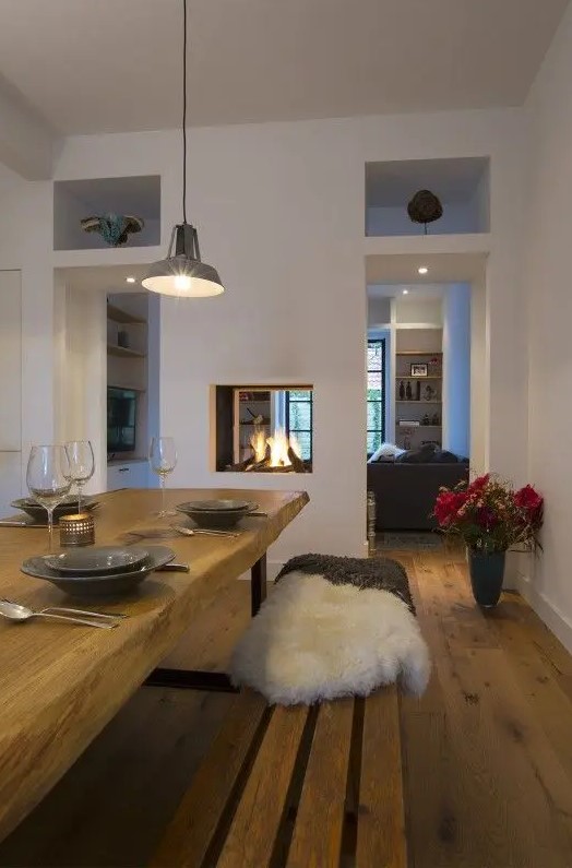 a built in double sided fireplace gives light and warmth to the dining and living room and separates them