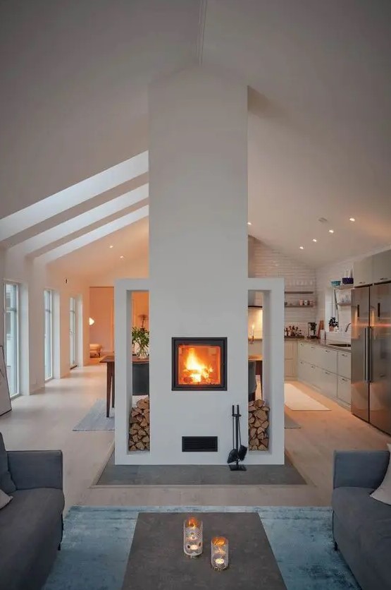 a built-in fireplace with firewood storage gives a lovely touch to both the living room and the kitchen