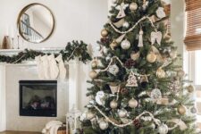 a chic and stylish Christmas tree with silver and gold ornaments, pinecones, wooden beads, angel ornaments and a star topper