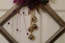 a chic metallic frame Christmas wreath with gold bells, purple glitter decor and leaves plus a word