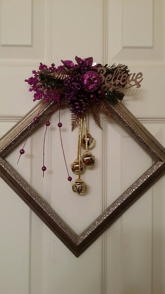 a chic metallic frame Christmas wreath with gold bells, purple glitter decor and leaves plus a word