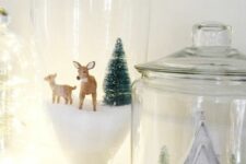 a couple of terrariums with faux snow, deer, bottle brush trees, a white house is a lovely idea for Christmas