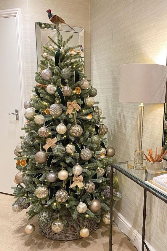 a fabulous Christmas tree with green, silver, gold, copper and other metallic ornaments, citrus slices and a bird topper