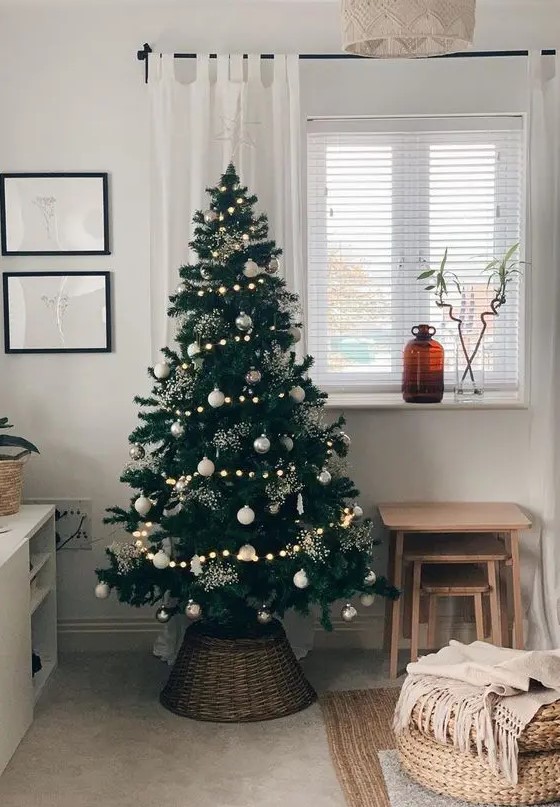 a gorgeous modern Christmas tree with lights, white and silver ornaments, shiny sparkles is a lovely idea for your modern space