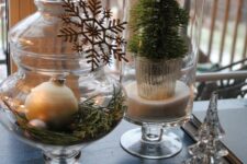 a jar with greenery, evergreens and ornaments plus silver snowflake is a chic and cozy idea for Christmas