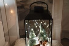 a lovely Christmas lantern with faux trees inside
