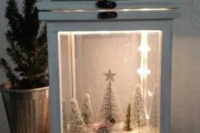 a lantern Christmas terrarium with faux snow, a vintage van carrying a tree, some snowy bottle brush trees and lights