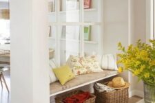 a large window from the living room to the entryway makes the little nook filled with natural light and makes it more welcoming
