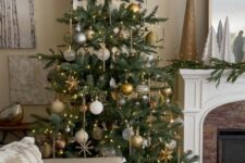 a lovely Christmas tree decorated with clear, white, silver and gold ornaments, lights, stars and snowflakes
