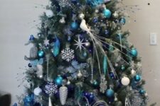 a lovely Christmas tree decorated with white and blue ornaments, snowflakes, branches, twigs and small birds is a beautiful idea to rock