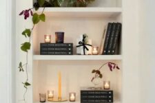 a lovely arched niche with shelves displaying books, candles and a potted plant is a stylish idea for a any space