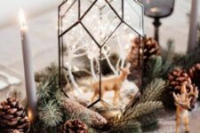 a mini Christmas terrarium with white lit up trees and a deer figurine is a cool idea for winter