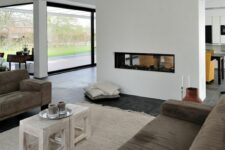 a minimalist white fireplace works for both living and dining rooms making them more welcoming and warm