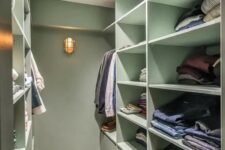 a mint green closet with shelves and drawers and built-in lights is a stylish idea with a soft touch of color