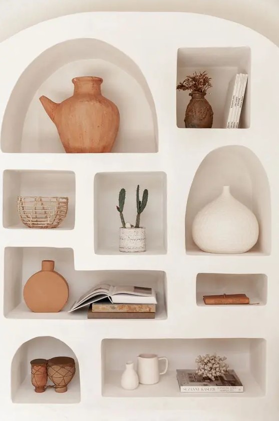 a neutral wall with a series of niche shelves is a great way to display various decor and accessories