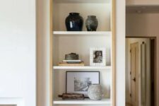 a niche with shelves lined up with stained wood is a stylish idea for a living room, here you can display anything you want