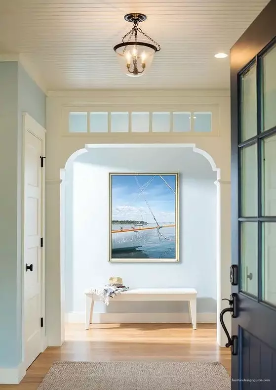 a refined entryway with a vintage feel, a transom window that adds more charm to the space and brings more natural light inside