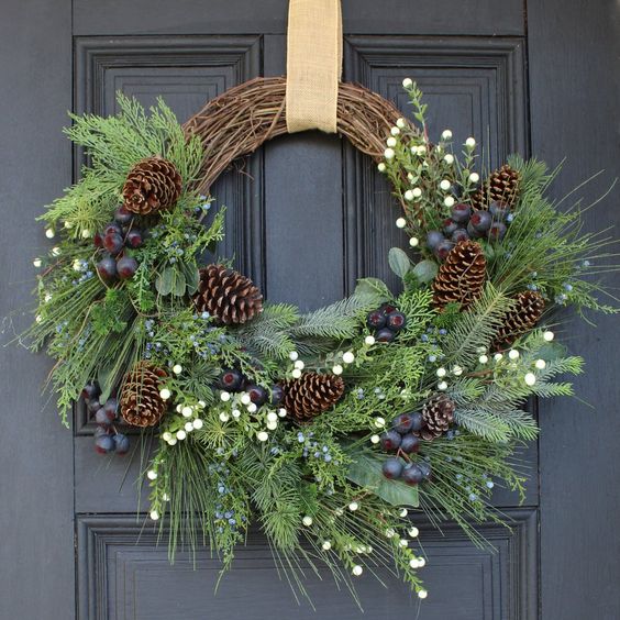 a rustic Christmas wreath of vine, evergreens, folaige, berries and pinecones is a gorgeous decoration for the holidays