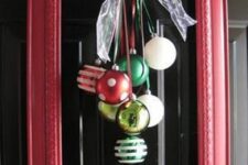 a simple and cool red frame Christmas wreath with white, red and green ornaments and a sheer ribbon bow
