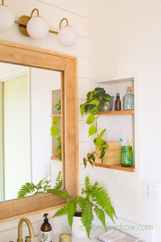 a small yet cool niche with light-stained shelves, a potted plant and some supplies is a lovely idea for a boho or mid-century modern space
