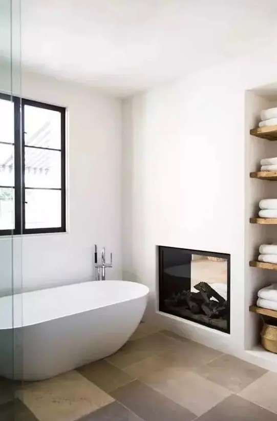 a contemporary bathroom with a fireplace