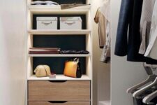 a tiny narrow closet with open lit up shelves, drawers and open storage units is a lovely space to be in