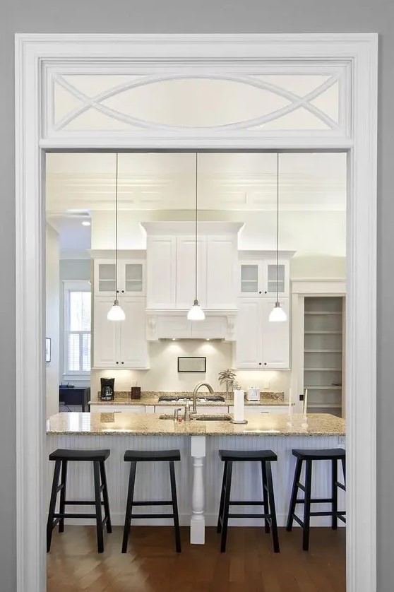 a traditional opening with a transom window that includes a pattern is a lovely and chic idea for a vintage space
